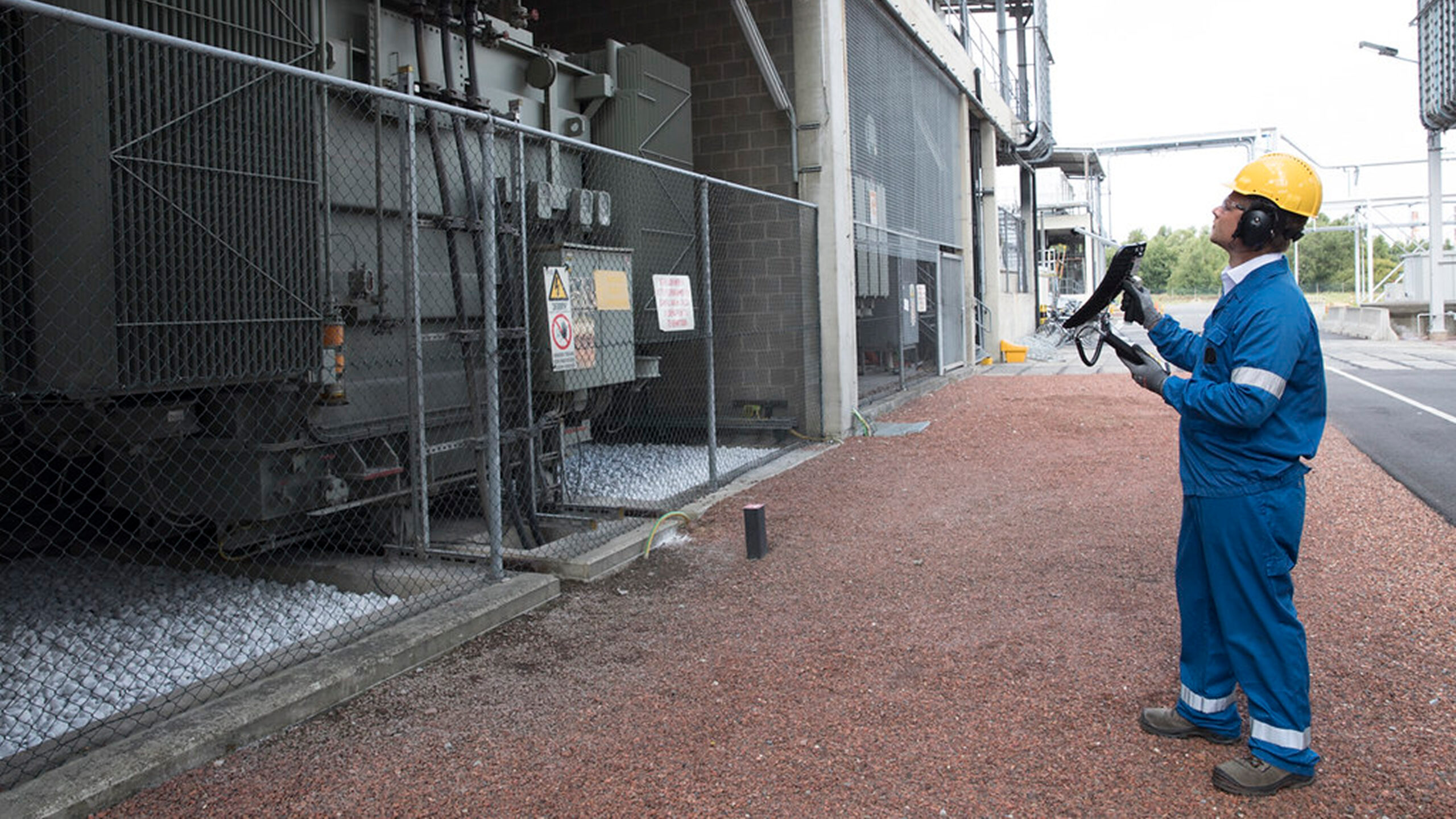 A photo of a technician using an handheld ultrasonic detector during a route-based inspection