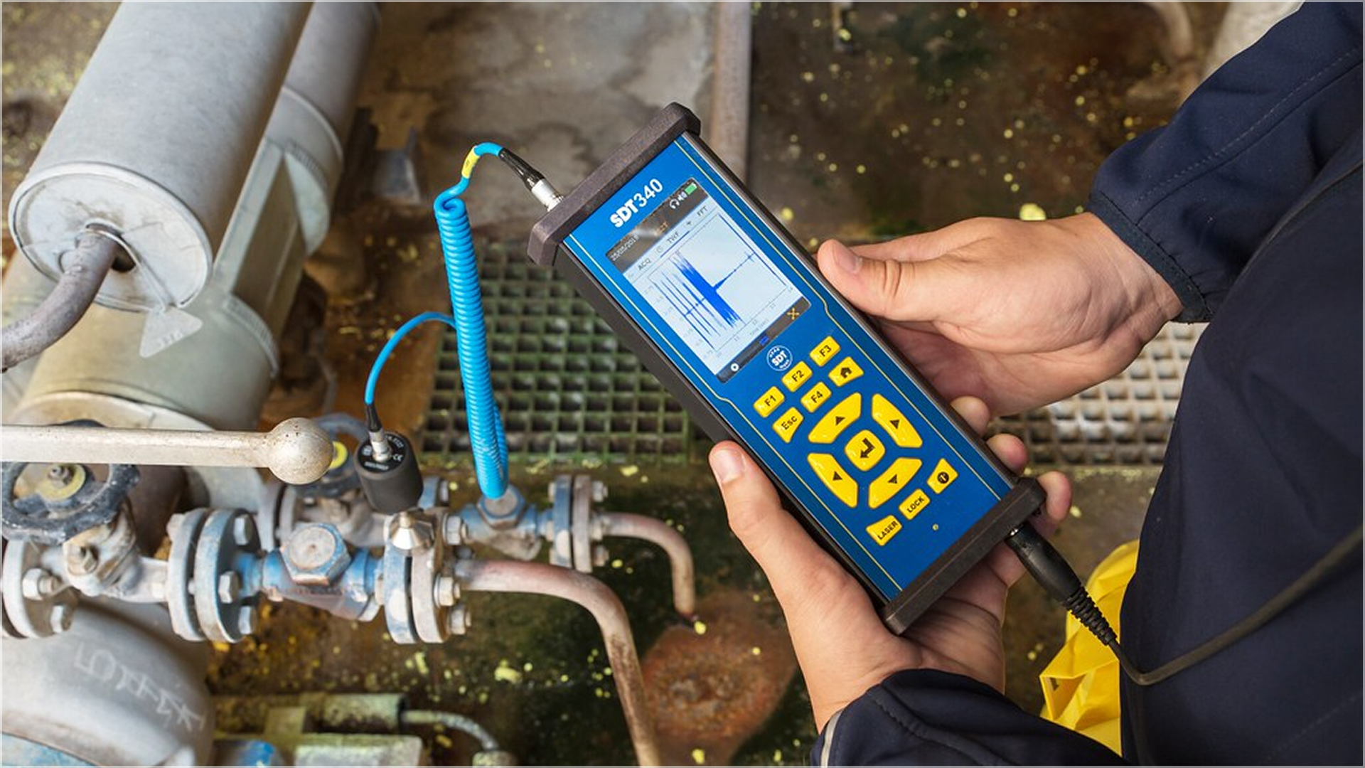 A technician doing Ultrasound Analysis using SDT340 detector in a Food & Beverage Plant